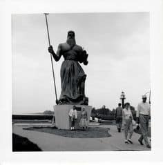 Tourists Pose at the Base of the King of Neptune